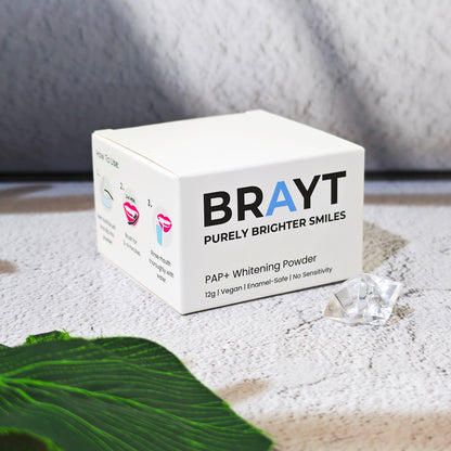 Box of BRAYT teeth whitening powder on a textured surface with a gray background